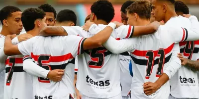 Jogadores do São Paulo se abraçando em campo.